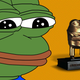 An image of Pepe the Frog sullenly staring at The Streamer Awards trophy, which is a gold-covered 3D printed model of Pepe the Frog in a suit and tie.